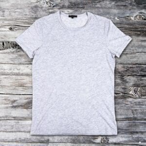 A grey T-Shirt on a wooden background.