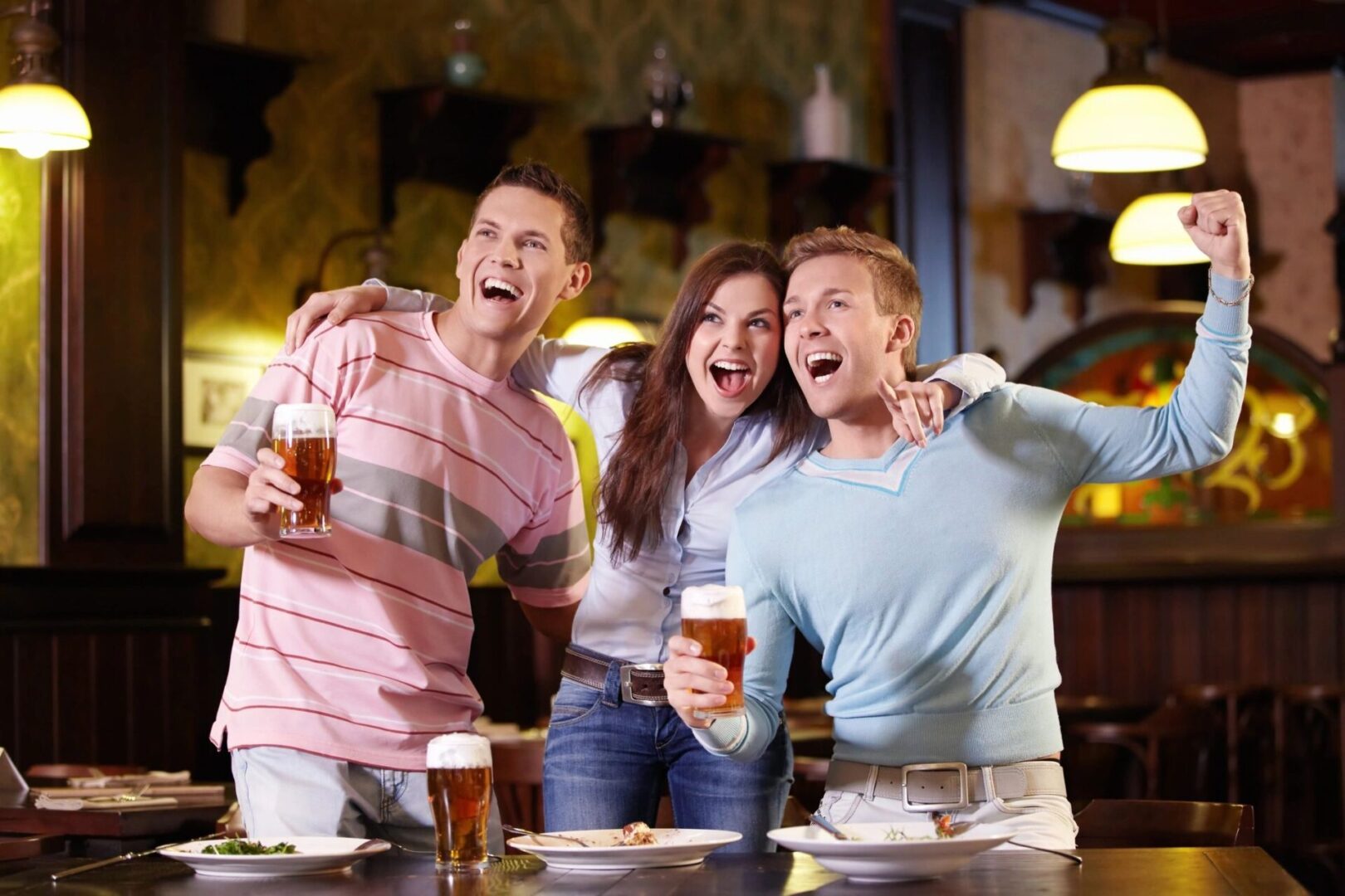 A group of people are having a good time in a bar.